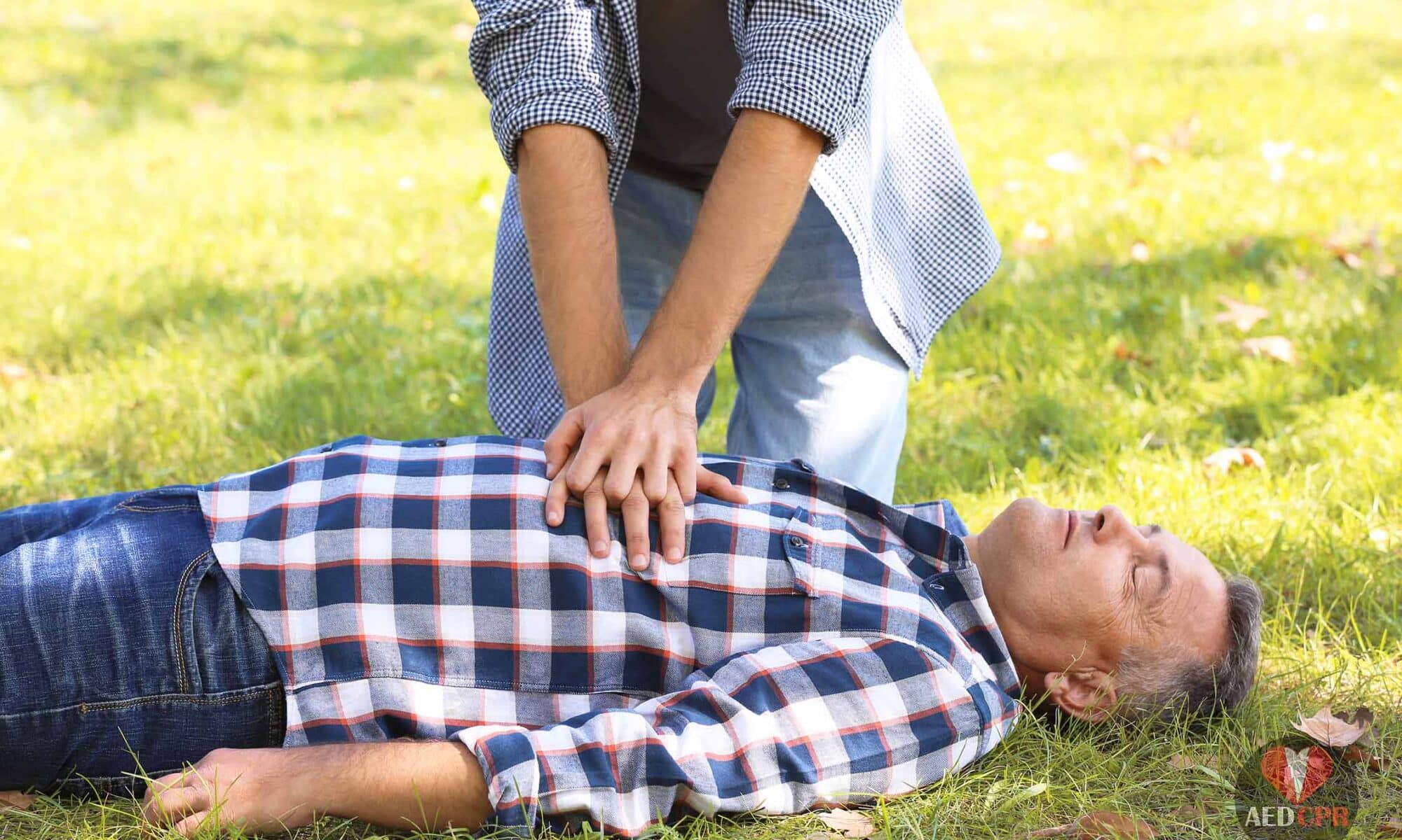 Woman shows how is CPR performed on an adult man.