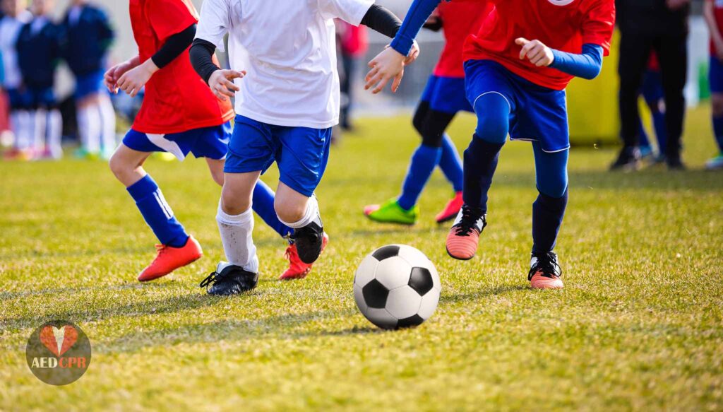 Group of kids playing soccer at school